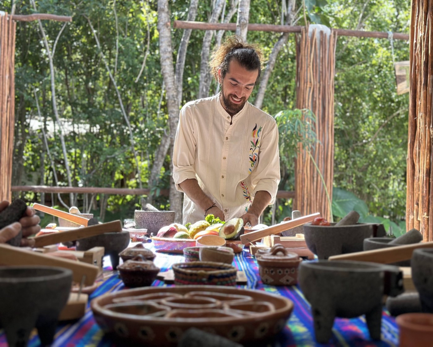 Our host preparing lunch, guests reaching in