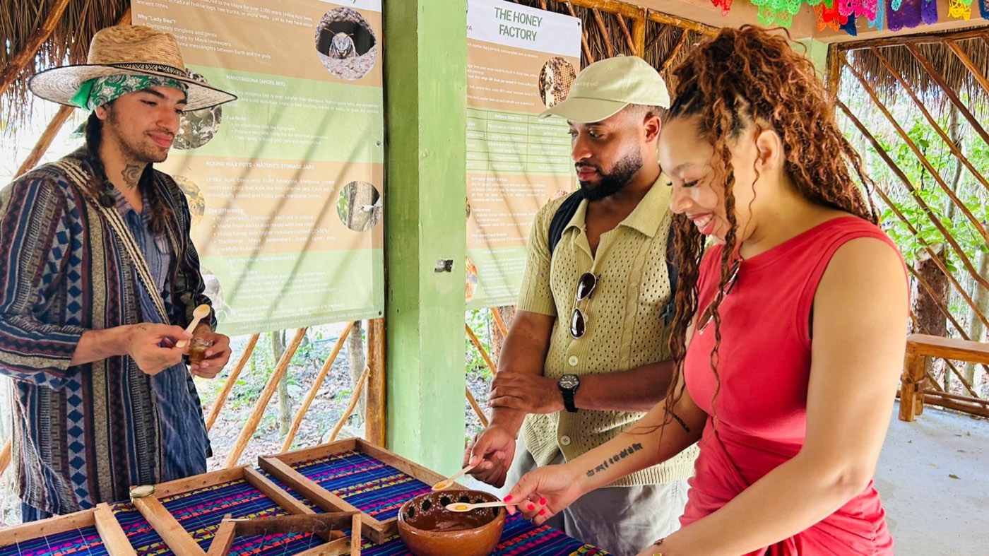 A Maya host and two guests tasting fresh melipona honey
