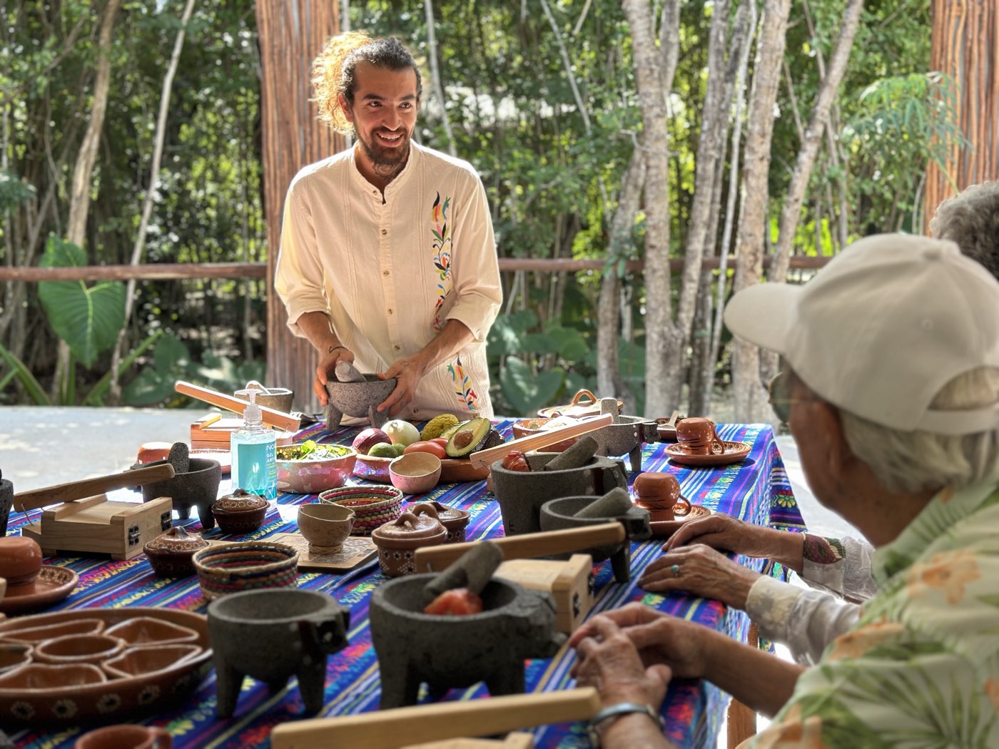 Guests cooking with our host in the jungle kitchen